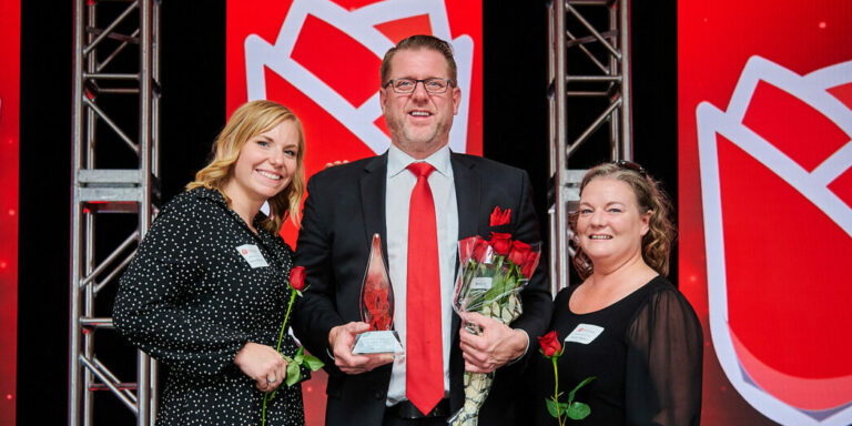 3 people holding awards at the Rose Awards